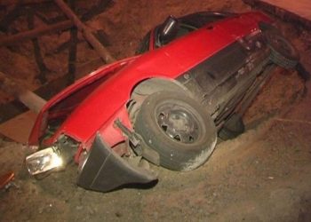 В Киеве автомобиль с людьми упал в яму на дороге